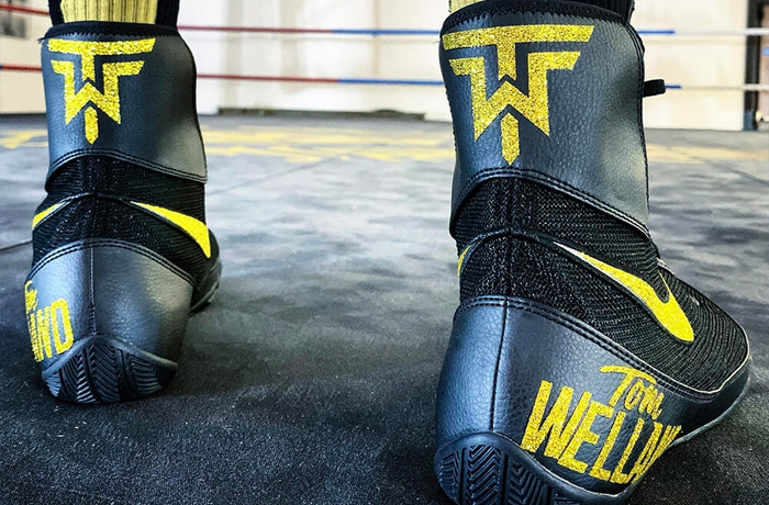 A boxer wearing custom made Nike Machomai boots